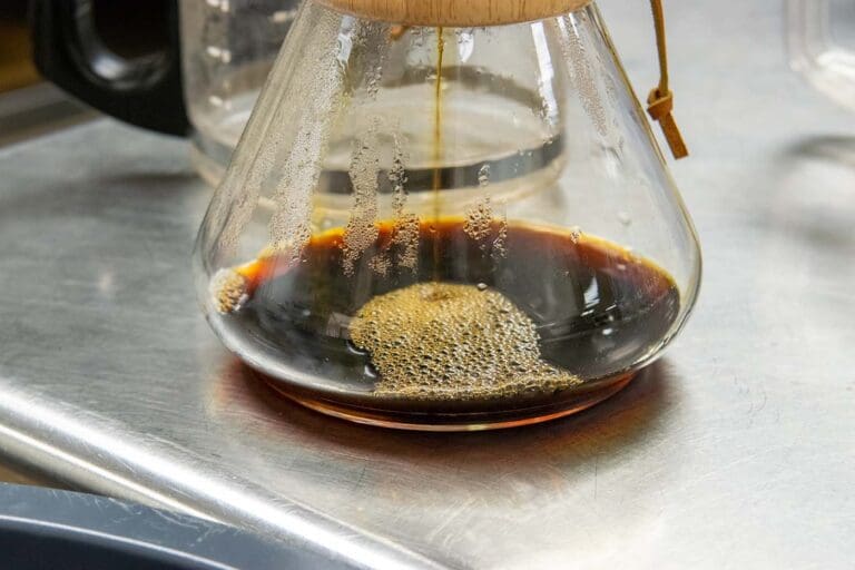 Fresh coffee dripping through a Chemex brewer