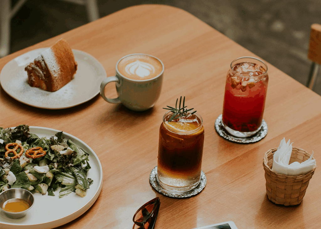 Table With Coffee, Soda, Juice, Salad, And Dessert.